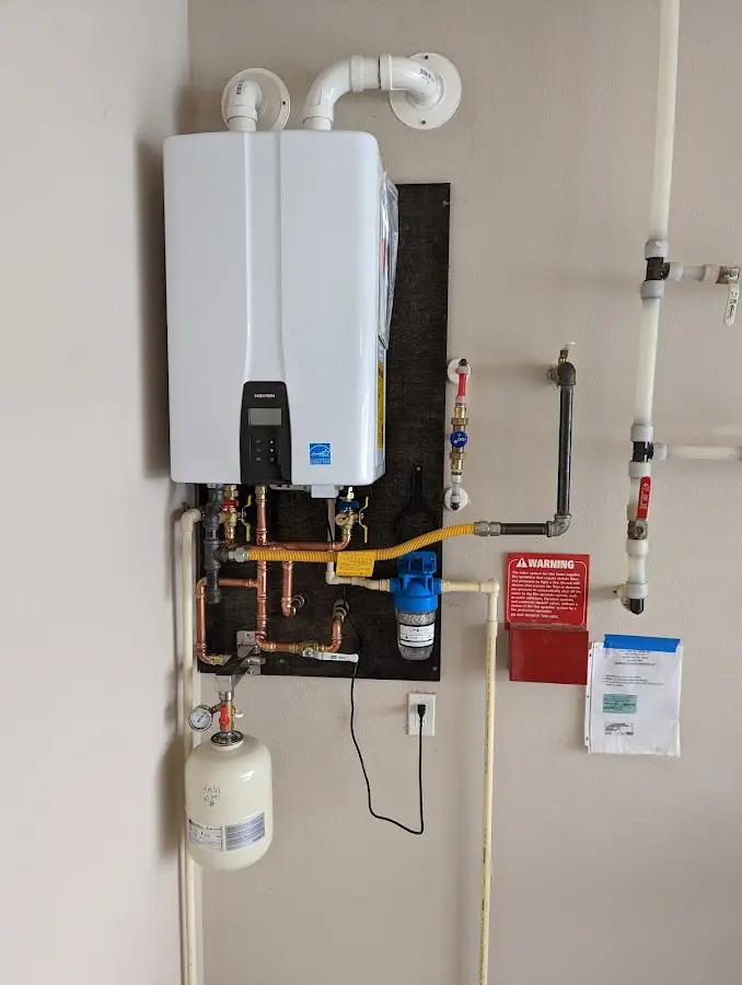 Professional plumber installing copper piping in a Madisonville home